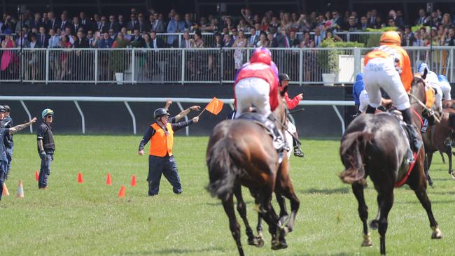 Officials steering the horses away at the end of the race, after The Cliffsofmoher suffered a fall. Picture: Alex Coppel