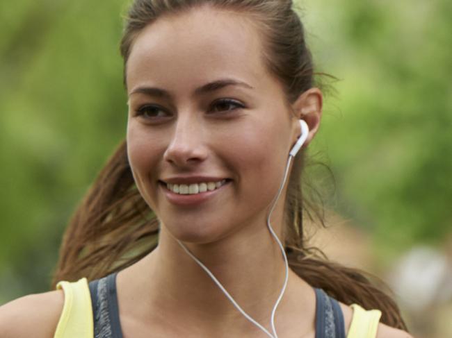 FEELING GREAT: APRIL 6, 2015Shot of a beautiful and sporty young woman listening to music while running outdoors