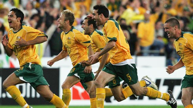 Tim Cahill, Scott Chipperfield, Tony Popovic, Tony Vidmar and Jason Culina celebrates the Socceroos’ win over Uruguay in 2005 that secured World Cup qualification. Picture: Getty Images