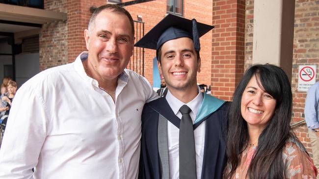 Vince, Michael and Maria Ghidinelli celebrate graduation. Picture: Brad Fleet