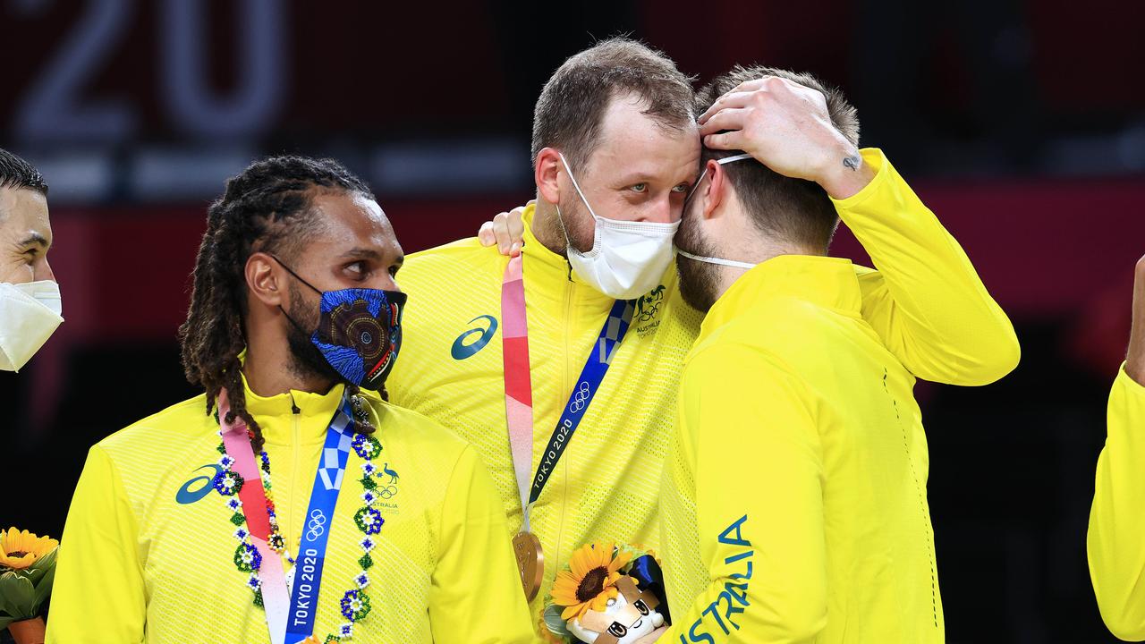 Patty Mills and Joe Ingles, and the recently cut Matthew Dellavedova, celebrate Australia’s bronze medal at the Tokyo Olympics. Picture: Adam Head