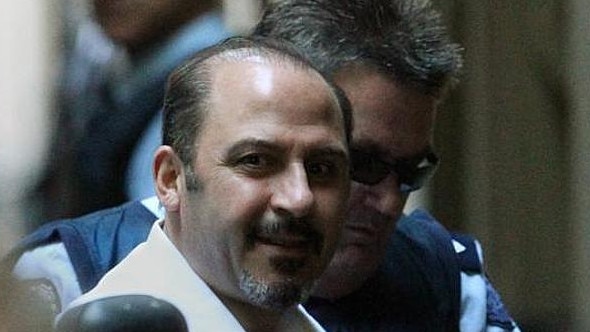 Mokbel looked in good spirits and took notes during the short hearing.