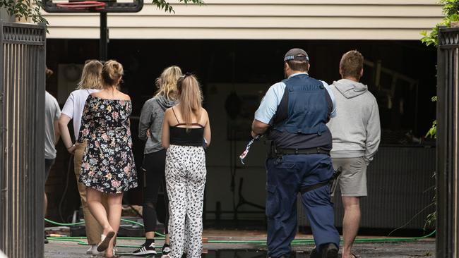 Family and friends inspect the aftermath of the house fire today. Picture: Julian Andrews.