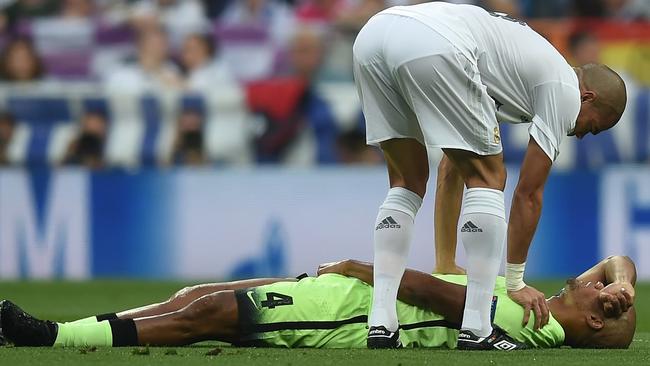 Pepe checks on the injured Vincent Kompany.