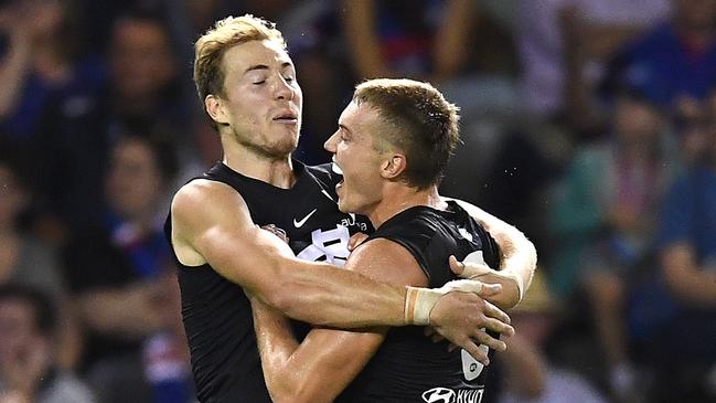 Harry McKay celebrates one of his four goals with skipper Patrick Cripps. Picture: Quinn Rooney/Getty Images. 