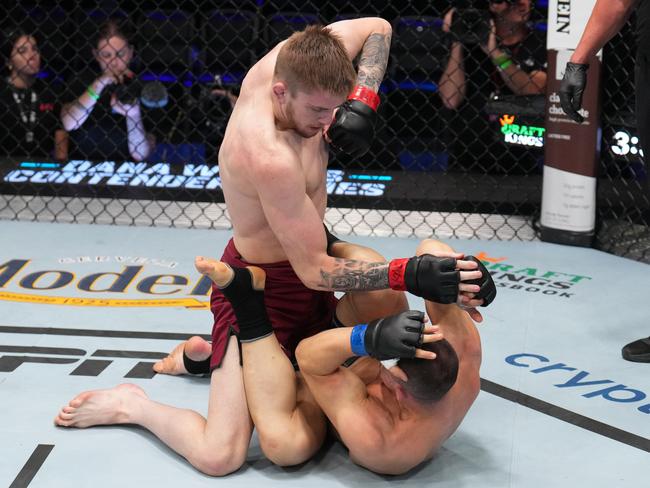 LAS VEGAS, NEVADA - AUGUST 08: (L-R) Tom Nolan of Australia elbows Bogdan Grad of Romania in a lightweight fight during Dana White's Contender Series season seven, week one at UFC APEX on August 08, 2023 in Las Vegas, Nevada. (Photo by Al Powers/Zuffa LLC)