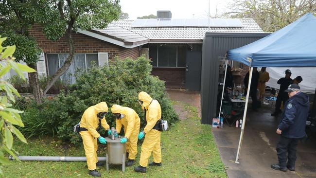 Crime-scene investigators remove sophisticated drug production equipment from drug lab found at the Morphett Vale house. Picture: Dean Martin