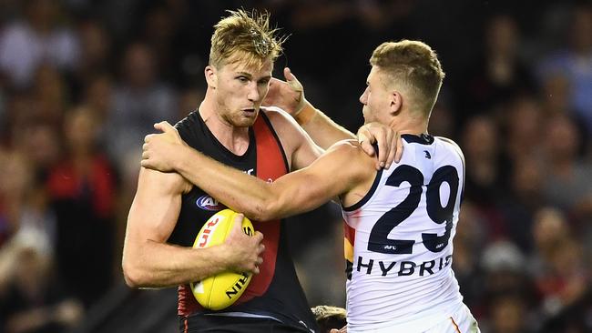 James Stewart of the Bombers is tackled by Rory Laird of the Crows. Picture: Quinn Rooney/Getty Images