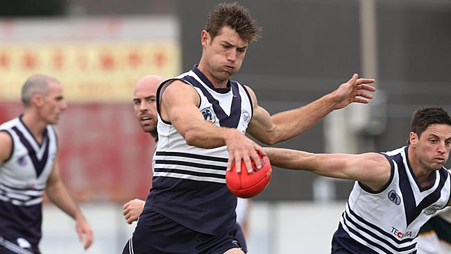 Matt Dennis kicks Bundoora forward. Picture: Ian Currie