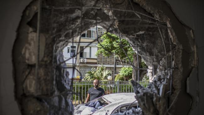 Surveying the damage from a rocket in the southern Israeli city of Ashkelon. Pictrure: Reuters