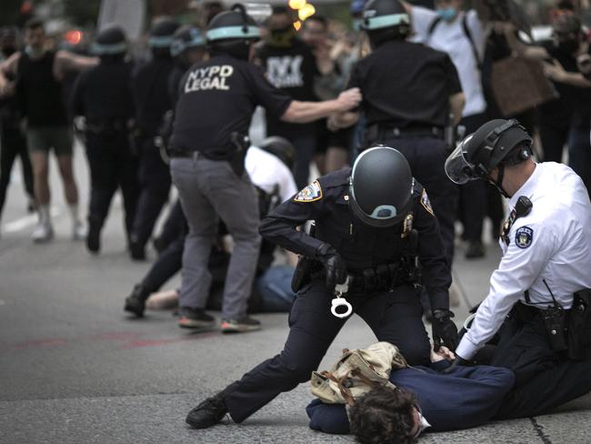 Police arrest a protester refusing to get off the streets during an imposed curfew in New York. Picture: AP