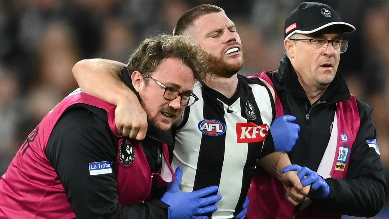 MELBOURNE, AUSTRALIA - SEPTEMBER 03: Taylor Adams of the Magpies is helped from the ground by trainers during the AFL First Qualifying Final match between the Geelong Cats and the Collingwood Magpies at Melbourne Cricket Ground on September 03, 2022 in Melbourne, Australia. (Photo by Quinn Rooney/Getty Images)