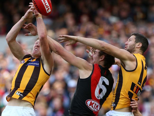 Joe Daniher flies for a mark against two Hawthorn opponents.