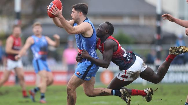 Sturt’s Henry Carey marks in front of Norwood’s Goy Lok at Unley Oval. Picture: Cory Sutton/SANFL.