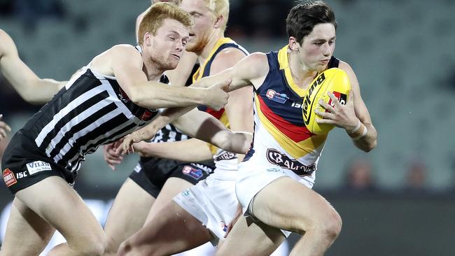 Crow Chayce Jones bursts away from the Power’s Willem Drew in last year’s SANFL qualifying final at Adelaide Oval. Picture: Sarah Reed.