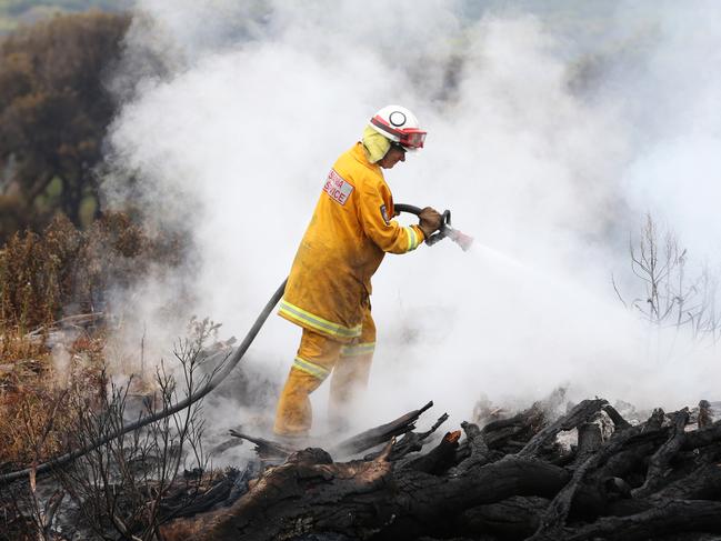 Tasmania Fire Service member putting out spot fires near Arthur River. Bushfires around North West Tasmania. Picture: NIKKI DAVIS-JONES