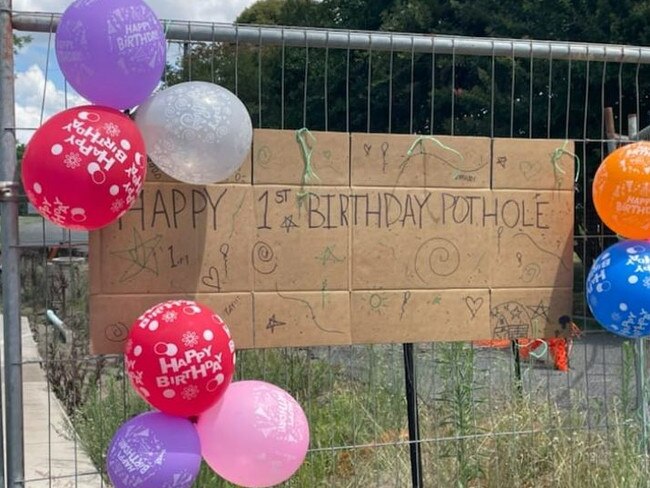 The gaping hole on Maudsley Street, Goomeri is closed off to vehicles and was decorated with decorated with birthday balloons and a large birthday card.