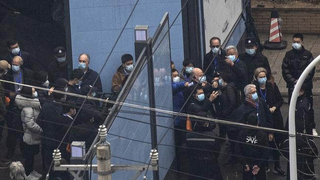 Security tight as the WHO team is ushered in. Picture: Getty Image