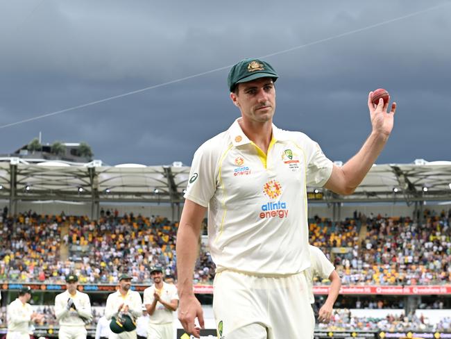 BRISBANE, AUSTRALIA - DECEMBER 08: Pat Cummins of Australia holds up the ball after taking five wickets in an innings during day one of the First Test Match in the Ashes series between Australia and England at The Gabba on December 08, 2021 in Brisbane, Australia. (Photo by Bradley Kanaris/Getty Images)