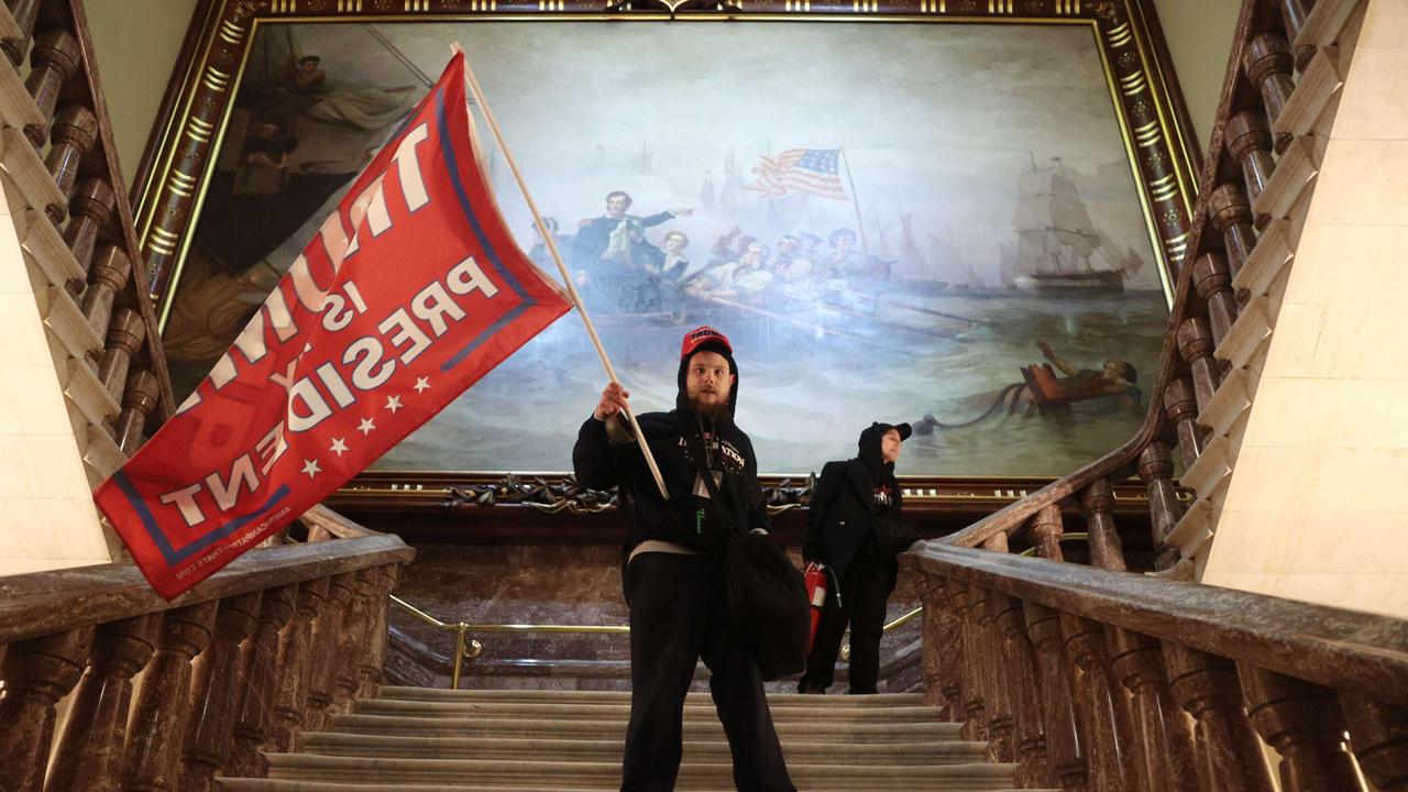 A protester holds a Trump flag inside the US Capitol Building near the Senate Chamber on January 06, 2021 in Washington, DC. Win McNamee/Getty Images/AFP