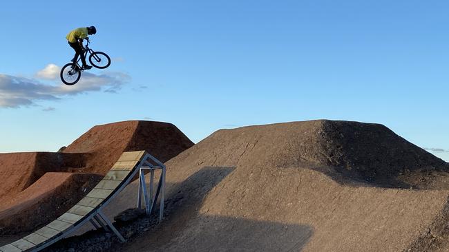 Jadon Wilson, 20, who has been working with Dirt Art on the new bike park track at Belrose. Picture: Trail Care/Matthew Ward.