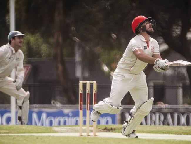 Sorrento opening batsman Corey Harris hits out as Langwarrin keeper Tom Hussey watches on. Picture: Valeriu Campan