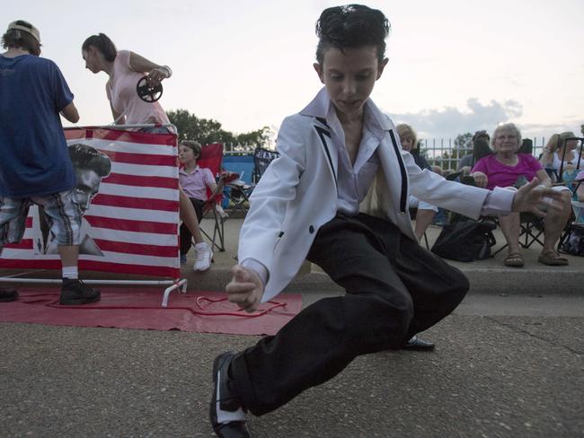 Young fan Nathan Pittorf shows off his best Elvis impersonation during a candlelight vigil for Presley at Graceland earlier this week. Picture: AP