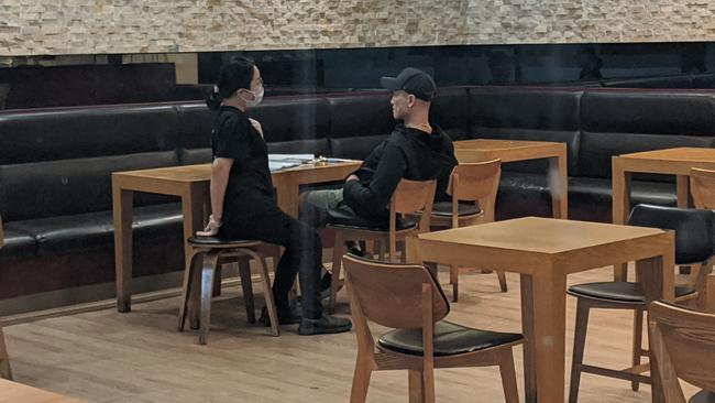 The owner of Madtongsan IV Korean restaurant at Sunnybank's Market Square (right) in conversation with an employee.