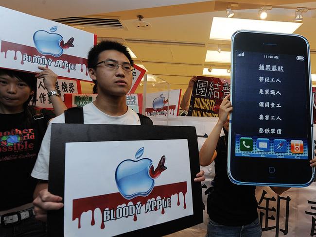 Protesters demonstrate during a day of remembrance for Foxconn workers who committed suicide outside a store selling Apple products in Hong Kong in 2010.