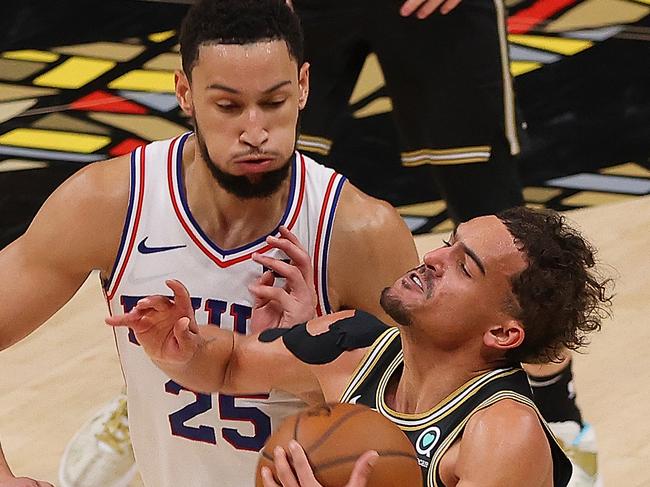 ATLANTA, GEORGIA - JUNE 14:  Trae Young #11 of the Atlanta Hawks draws a foul from Ben Simmons #25 of the Philadelphia 76ers during the second half of game 4 of the Eastern Conference Semifinals at State Farm Arena on June 14, 2021 in Atlanta, Georgia.  NOTE TO USER: User expressly acknowledges and agrees that, by downloading and or using this photograph, User is consenting to the terms and conditions of the Getty Images License Agreement. (Photo by Kevin C. Cox/Getty Images)