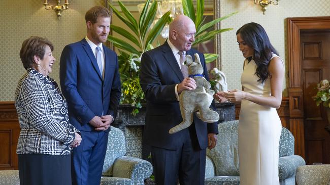 Cosgrove and his wife Lynne present a toy kangaroo to Prince Harry and Meghan in 2018. Picture: Steve Christo