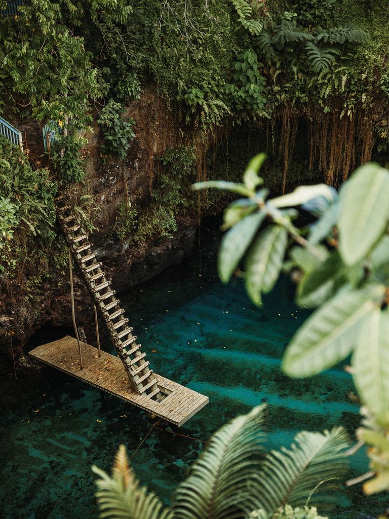 Visitors climb down a long wooden ladder to reach the pool. Pic: Supplied