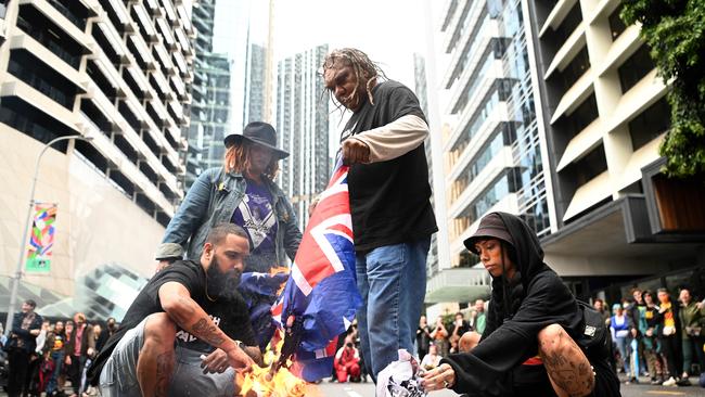 First Nations protesters burn the British flag during an anti-monarchy rally in central Brisbane. Picture: Dan Peled