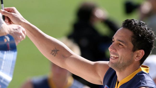 Adelaide Crows legend Andrew McLeod signing autographs during his playing days.