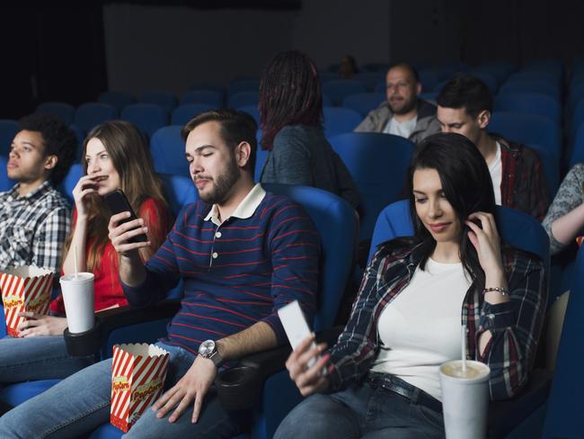 The nightmare of modern cinema-going: small screens competing with the large one.