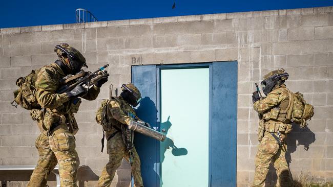Australian army soldiers from the 3rd Battalion, Royal Australian Regiment, breach a door during the conduct of an urban assault serial using the Blue Bolt non-lethal training ammunition as part of the 2022 Duke of Gloucester Cup in Singleton. *** Local Caption *** Australian Army infantry soldiers from across Australia tested their core skills for the prestigious Duke of Gloucester Cup at the School of Infantry, near Singleton in NSW, July 31 - August 5 2022. The Duke of Gloucester Cup is the Armyâ€™s premier military skills competition, pitting the best Royal Australian Corps of Infantry rifle sections from each unit against one another through a series of challenging activities that test their core infantry skills, including marksmanship, tactics, teamwork and fitness. Along with the Duke of Gloucester Cup, five other trophies are awarded: Sir Arthur MacDonald Trophy for best foundation war-fighting skills; Gurkha Trophy for best live-fire shooting; Royal Ulster Rifles Trophy for best falling plate shooting; OSCMAR Trophy for best battle endurance; and the DSM Roche CSC Memorial Cup for best individual soldier. The Duke of Gloucester Cup was created by Prince Henry, Duke of Gloucester, in 1946, while serving as the Governor-General of Australia.