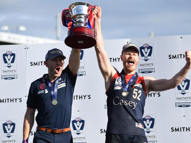 MELBOURNE, AUSTRALIA - SEPTEMBER 18: Mark Corrigan, coach of the Casey Demons and Mitch White of the Casey Demons celebrate after the 2022 VFL Grand Final match between the Casey Demons and the Southport Sharks at Ikon Park on September 18, 2022 in Melbourne, Australia. (Photo by Felicity Elliott/AFL Photos via Getty Images)