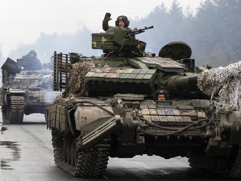 Ukrainian servicemen ride on tanks towards the front line with Russian forces in the Lugansk region of Ukraine on February 25. Picture: AFP