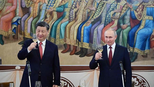 Vladimir Putin and Xi Jinping at a reception following their talks at the Kremlin. Picture: AFP.