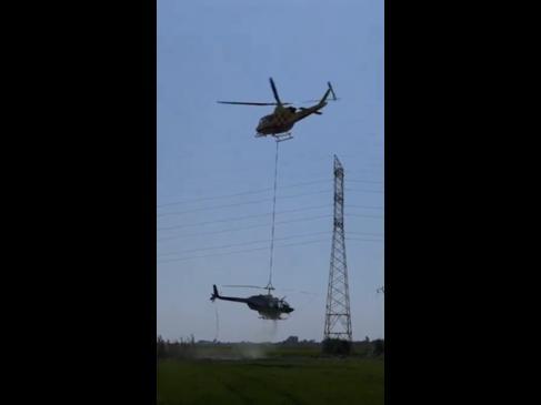Helicopter airlifted by another chopper after collision with power lines