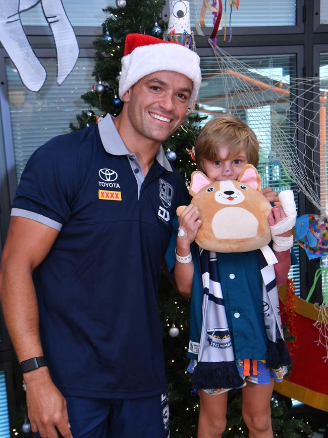 Cowboys Braidon Burns paid a surprise visit to patients, including Lane Edwards, 7, from Bluewater, at the Childrens' Ward at the Townsville University Hospital. Picture: Evan Morgan