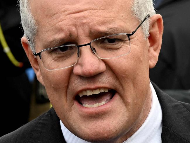 Australian Prime Minister Scott Morrison speaks to the press after casting his vote outside a polling station during the Australian general election in Sydney on May 21, 2022. (Photo by SAEED KHAN / AFP)