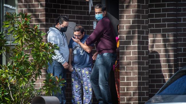 Ayan’s dad is comforted at their Blackburn South home. Picture: Tony Gough
