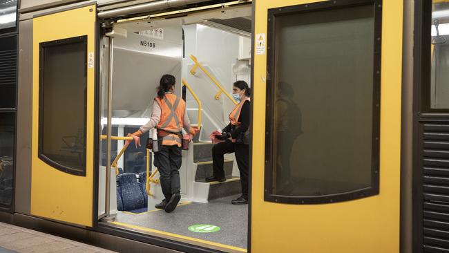 Staff clean handrails on a train at Bondi Junction Station on May 19 in Sydney. Picture: Getty Images