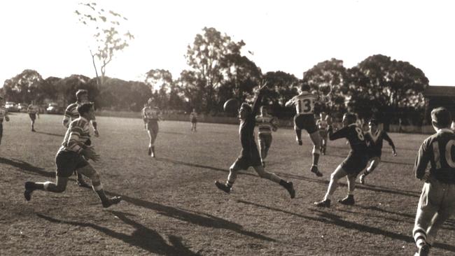 1954 GPS Rugby Premiers. Les James, second row, charges down a kick. Photo supplied.