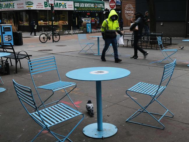 Empty tables sit outside of restaurants in downtown Brooklyn. Picture; Getty Images.