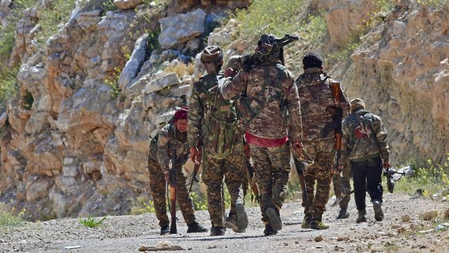 Syrian Democratic Forces fighters patrol near Baghouz yesterday. Picture: AFP