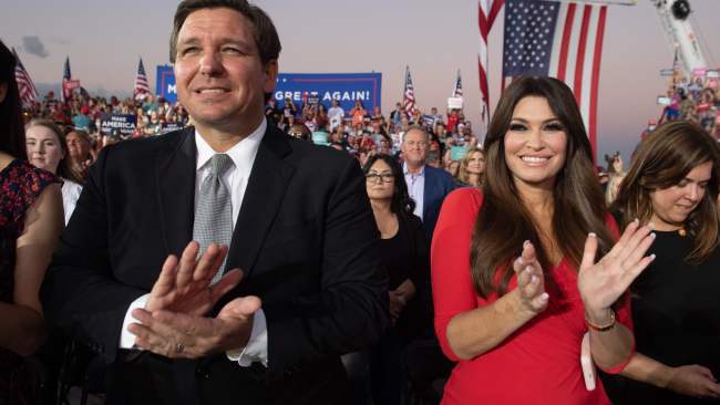 Florida Governor Ron DeSantis is being widely tipped to make a run for the presidency in 2024. DeSantis is pictured left at a Donald Trump campaign rally at Orlando Sanford International Airport in October 2020 (Photo by SAUL LOEB / AFP)