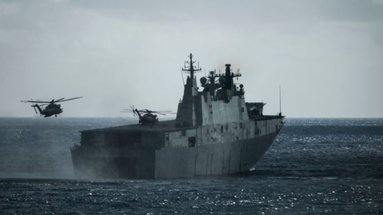 HMAS Adelaide practices deploying troops via helicopter and landing craft. These big, valuable troop ships are immensely vulnerable on the modern battlefield. Picture: ADF