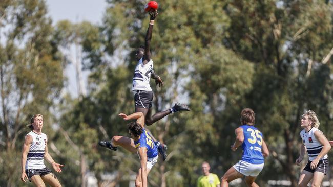 Dominic Akuei jumps over Paul Tsapatolis. Picture: Valeriu Campan